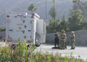 GCC Police and Glendale Fire wait by the LA Sheriff Bomb Squad vehicle Monday, while the bomb squad checked out the package in the parking structure.